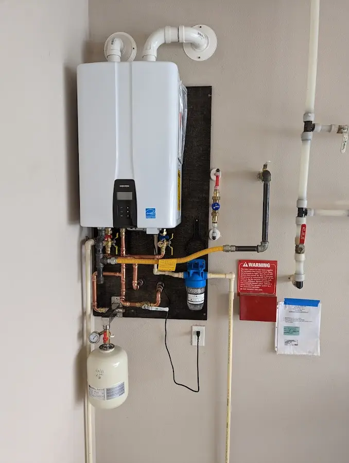 Professional plumber installing copper piping in a Cape Elizabeth home